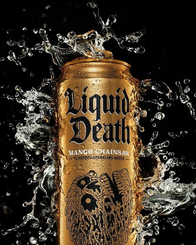 Liquid Death Mango Chainsaw can surrounded by splashing water